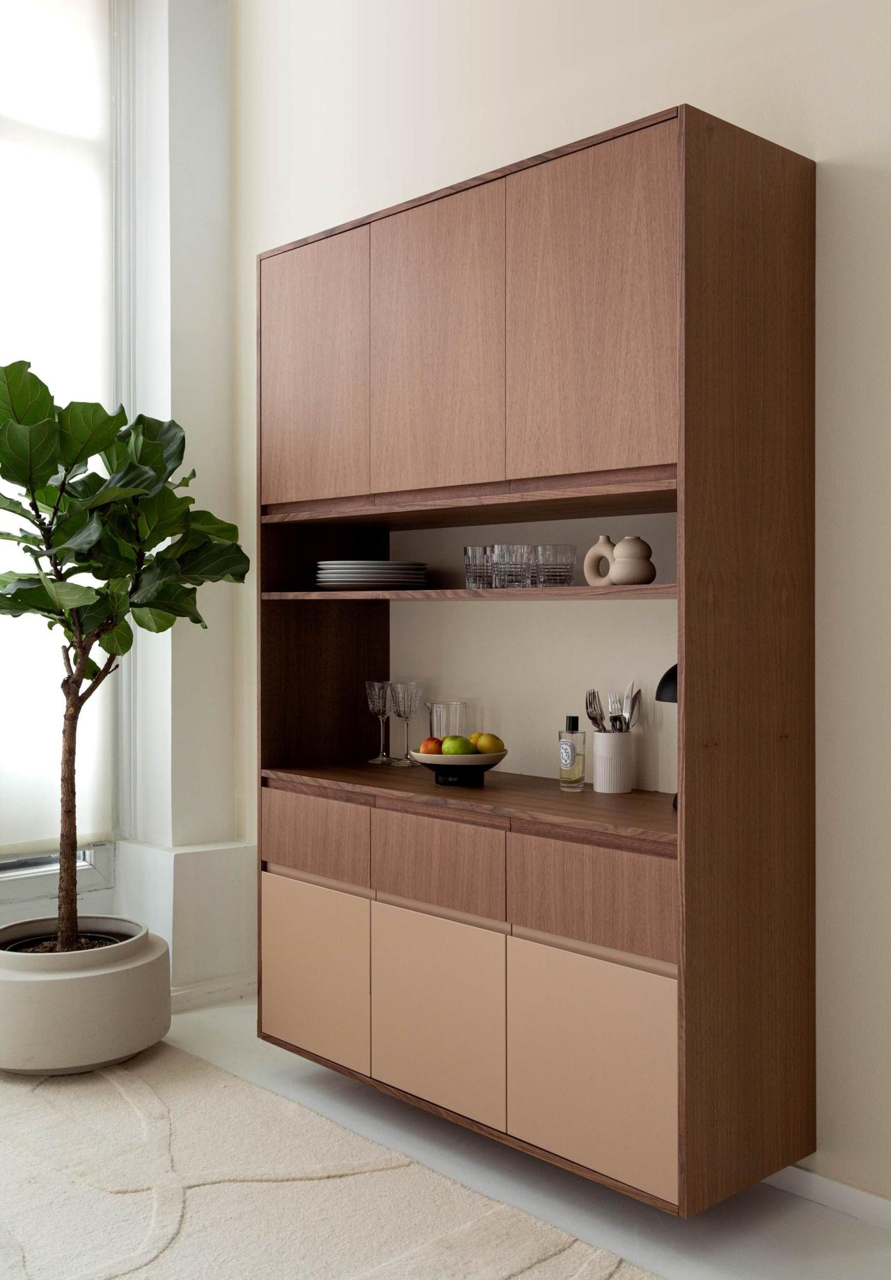 A china cupboard in natural walnut and moka