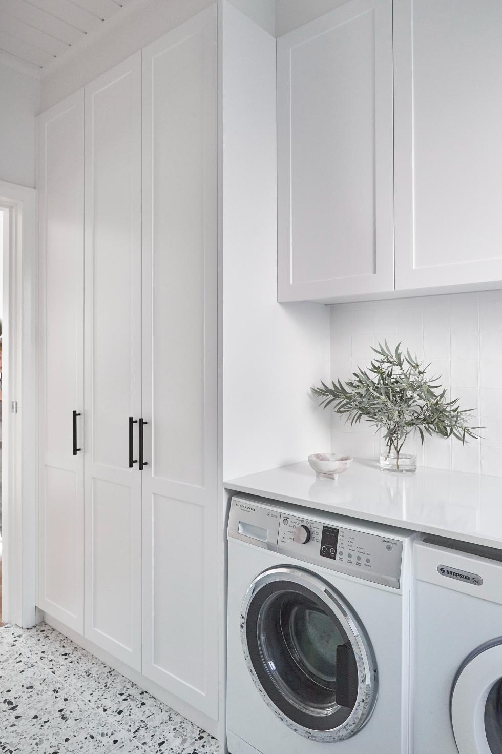 White laundry room with framed fronts